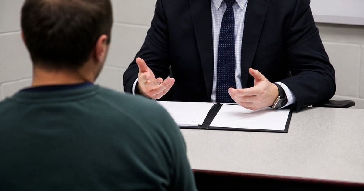 Police station representative explaining adverse inference to a client before interview