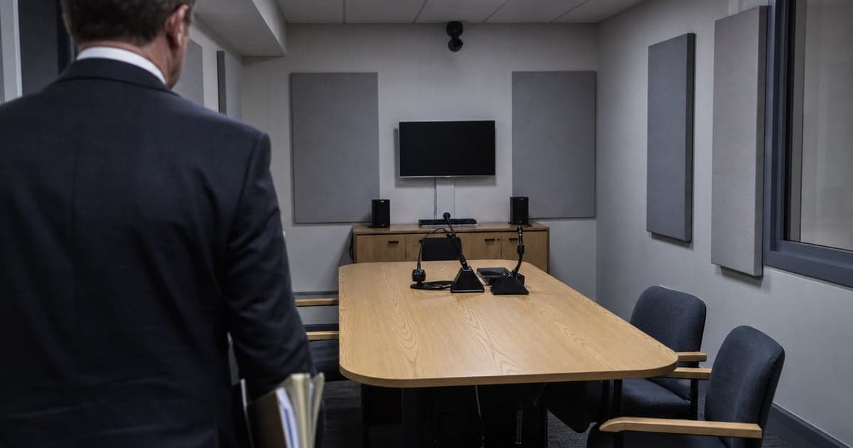 Police station representative advising a client before a voluntary police interview